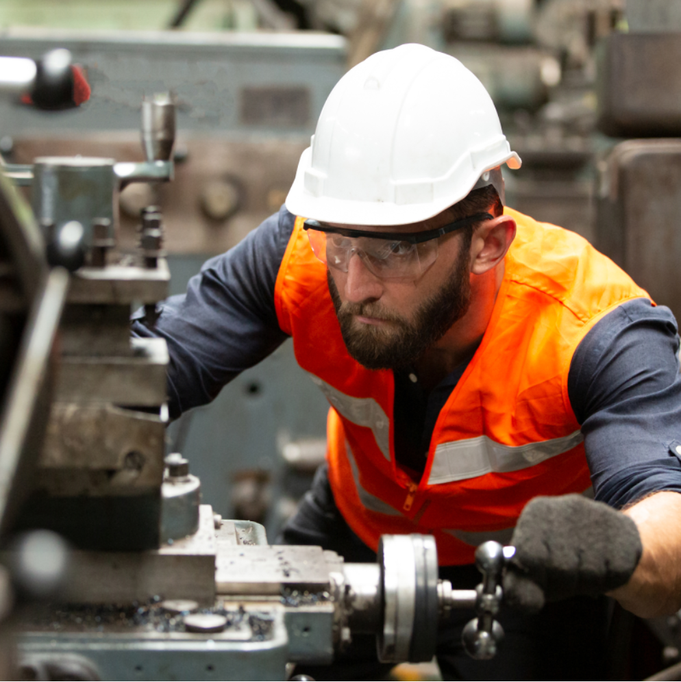 Engineer in high visibility jacket fixing a machine